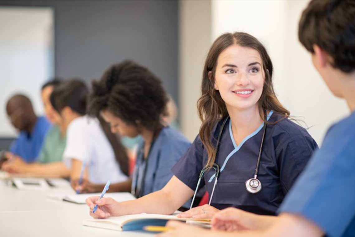 Nursing students studying together at a table